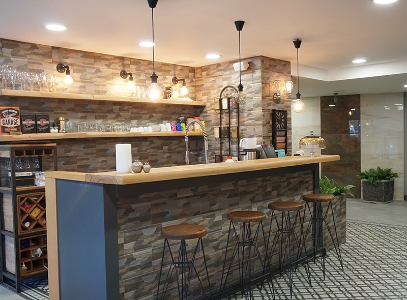AsyaKBB - Ana Sayfa 12 Asya KBB kliniğinde taş duvarlı, yüksek tabureli kafe köşesi